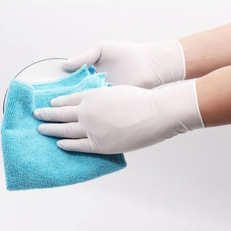 Hand wearing a white glove cleaning a surface with a blue cloth on a light gray background