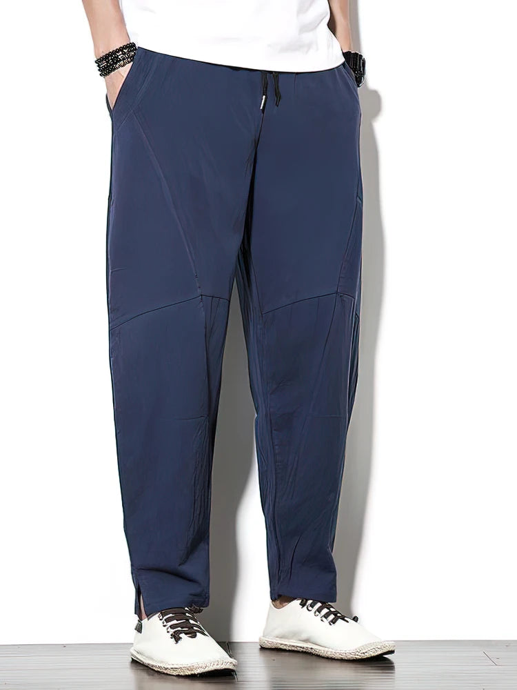 Person wearing navy blue pants on a white background