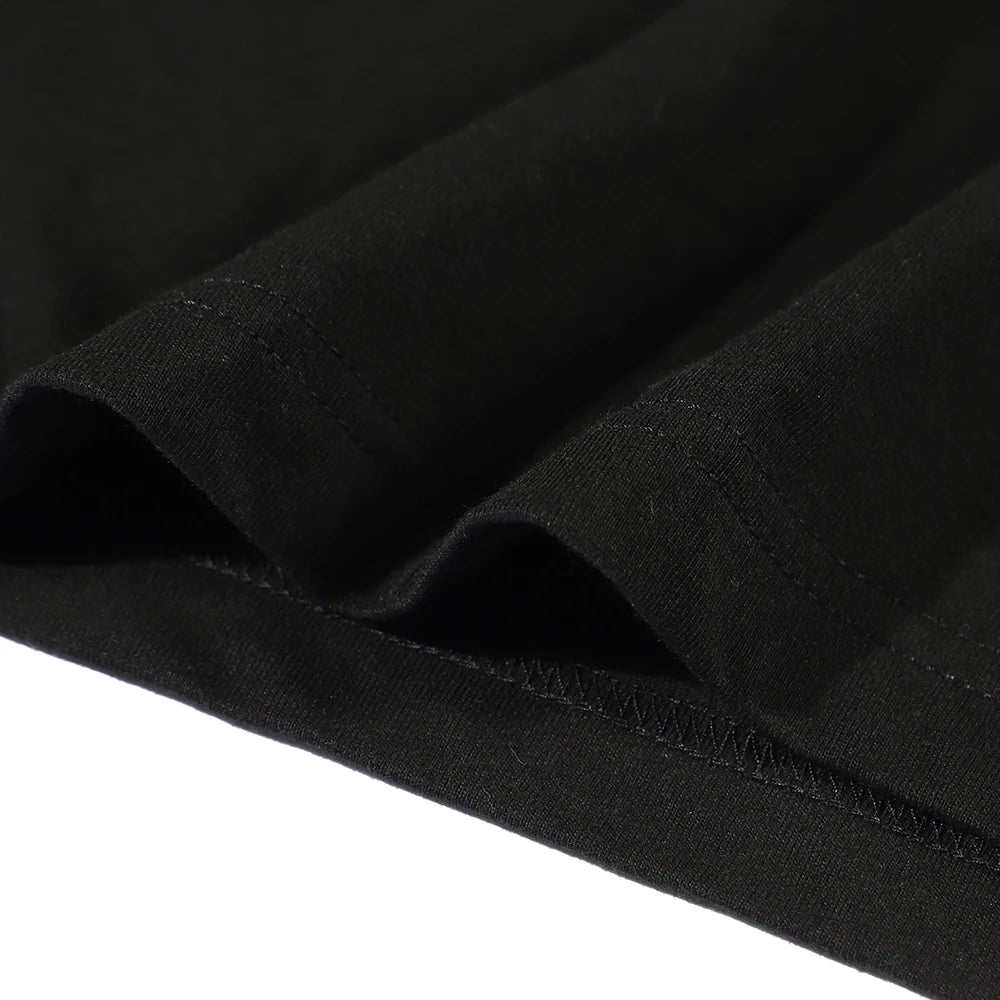 Close-up of black fabric with a visible seam on a white background