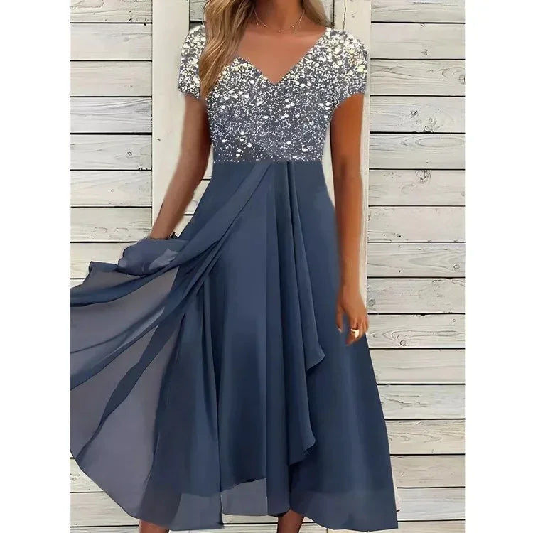 Blue dress with silver sequin top against a wooden background