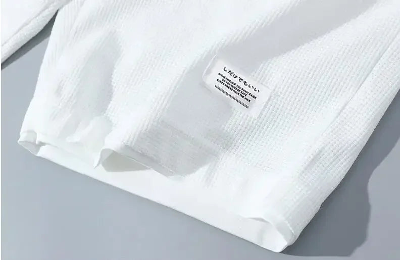 White textured fabric with a label on a gray background