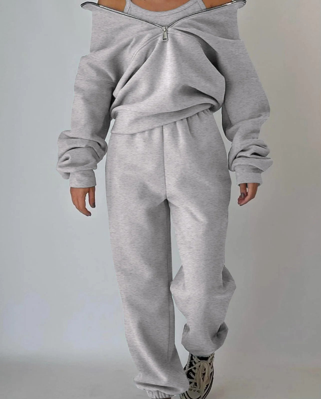 Gray sweatshirt and pants set on a plain background