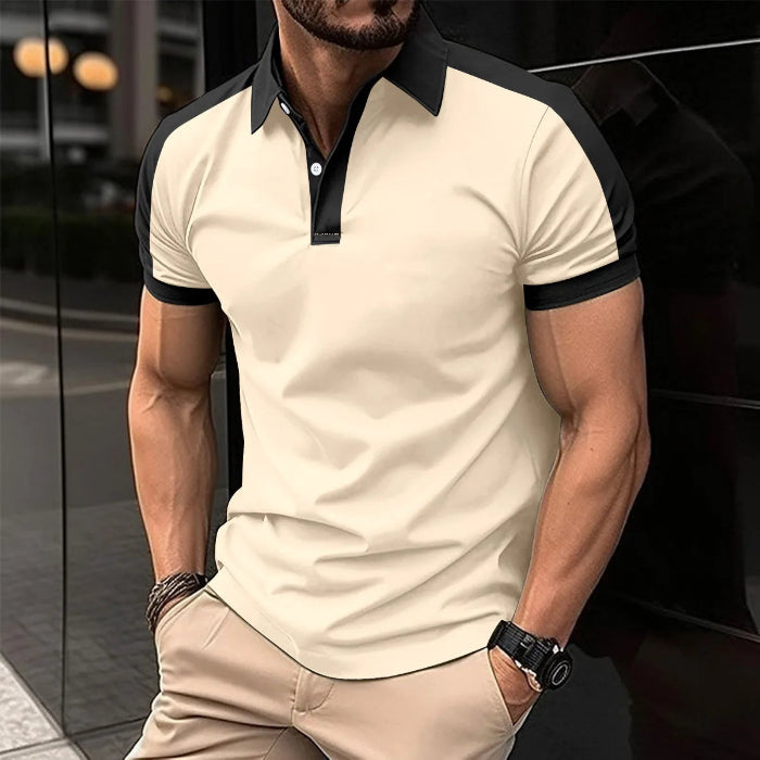 A man wearing a red and black patchwork polo shirt with short sleeves and a collar.