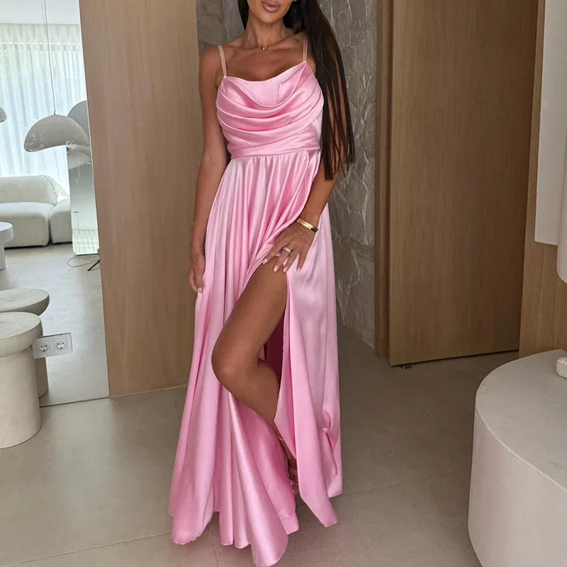 Woman wearing a pink dress with a slit in a modern indoor setting