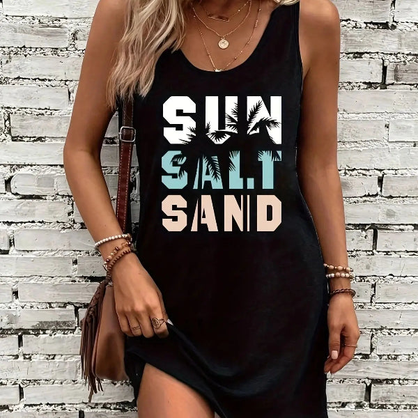 A sleeveless black tank top dress with text print 'SUN SALT SAND' on a woman standing outdoors, carrying a brown purse and wearing a watch.