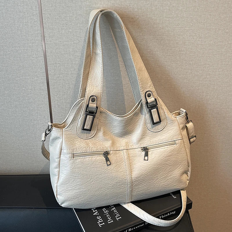 Beige handbag on a textured surface with a neutral background