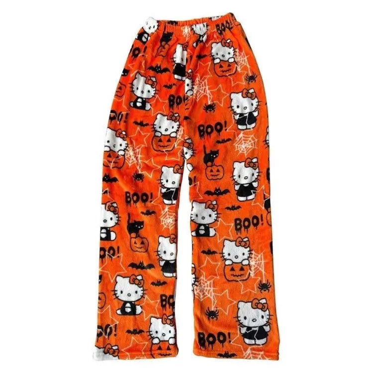 Orange Halloween-themed pajama pants with Hello Kitty and pumpkins on a white background