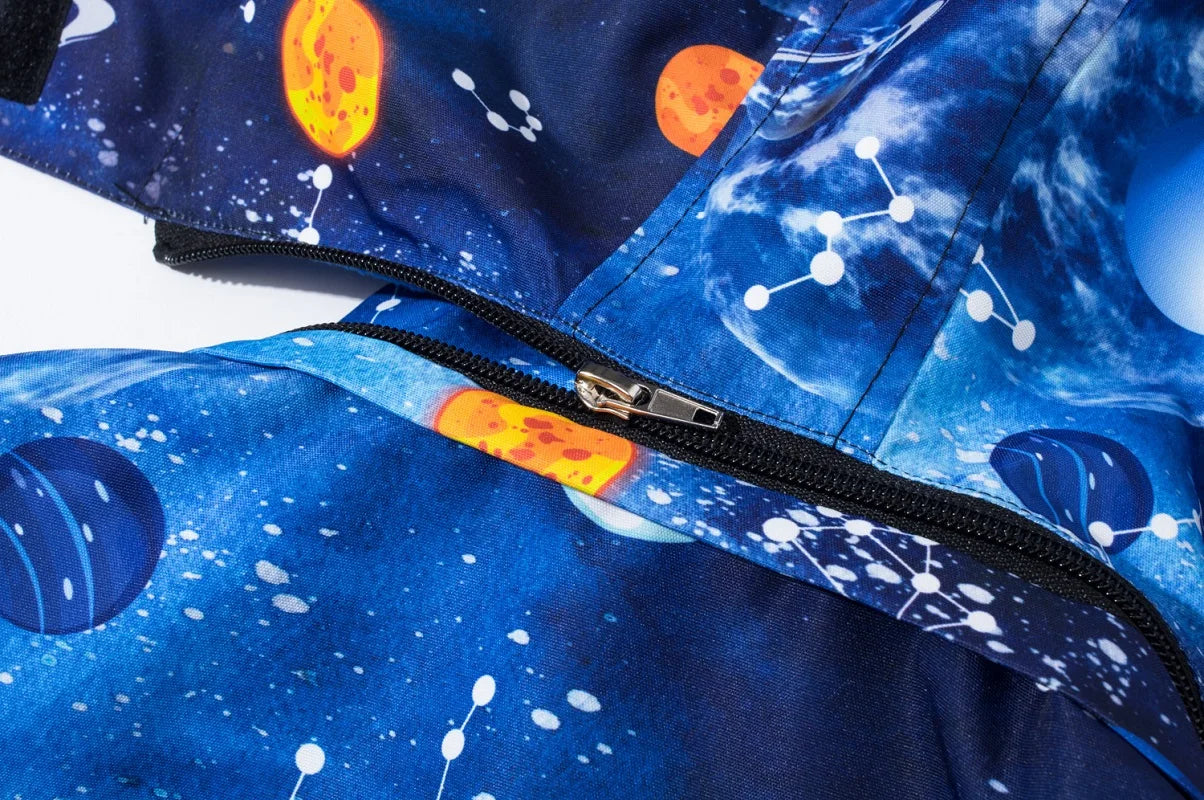 Close-up of a space-themed jacket with planets and stars on a blue background.