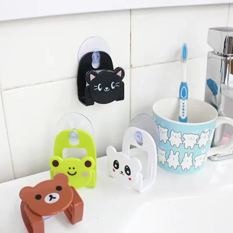 Set of colorful animal-themed toothbrush holders on a bathroom counter with a mug and toothbrush.