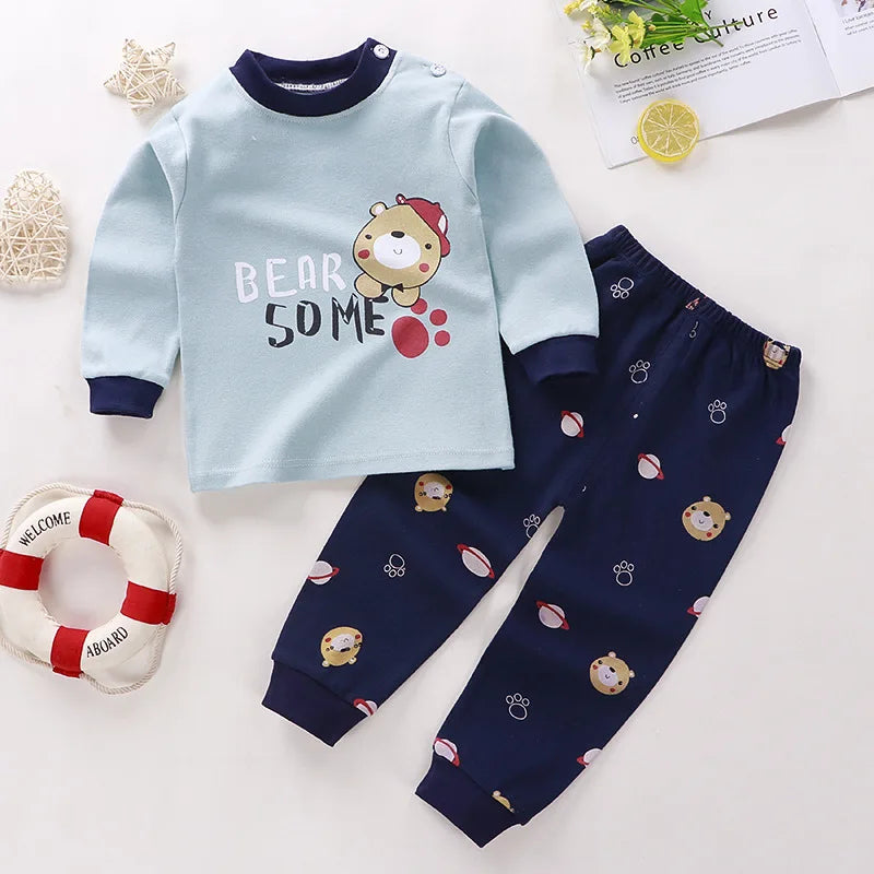 Toddler wearing a soft cotton Minnie-themed top and pants set, smiling in a sunny park with spring flowers around blue