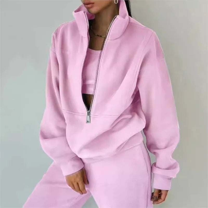 Person wearing a pink tracksuit against a plain background