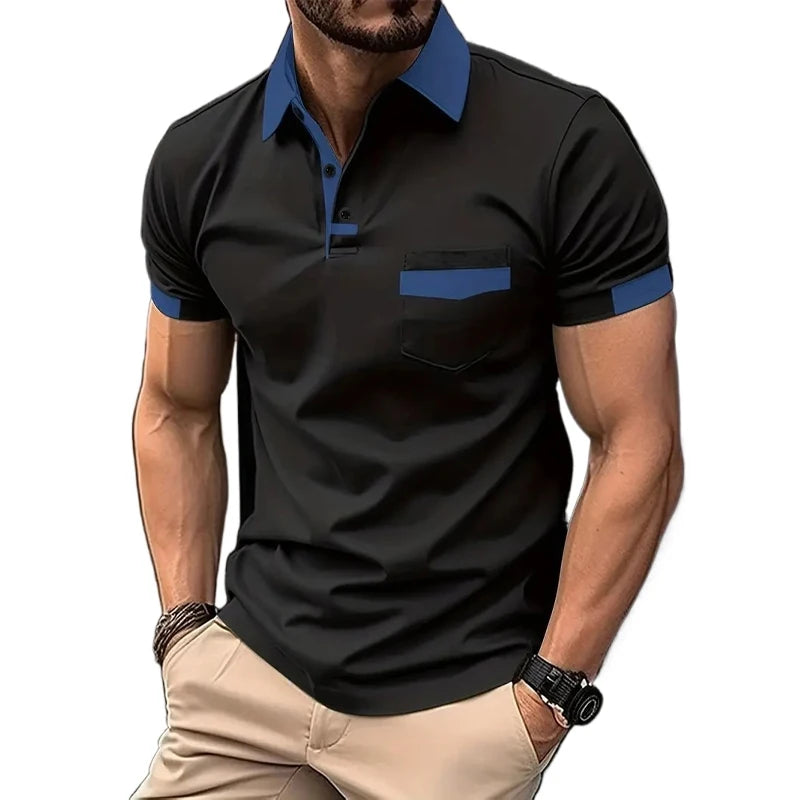 A man wearing a short-sleeved beige polo shirt with blue collar and pocket trim, and light beige shorts.