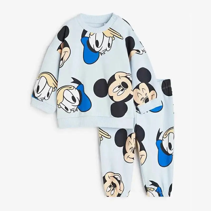 Children's pajama set with cartoon character faces on a light blue background
