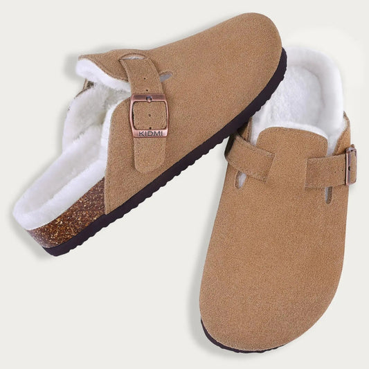 Pair of tan slippers with white lining on a light gray background