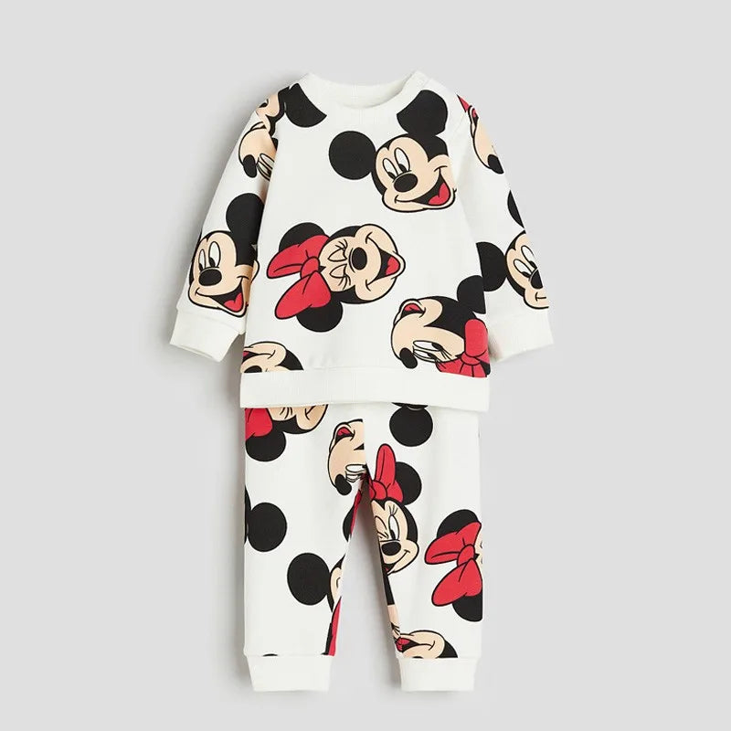 Children's pajama set with cartoon character print on a light gray background