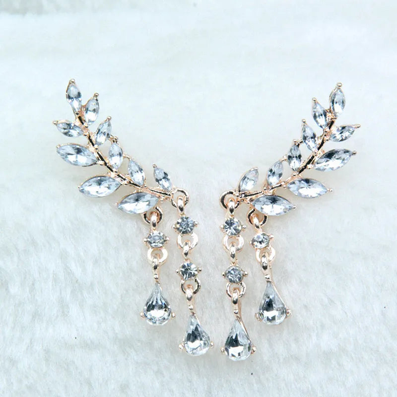 Elegant earrings with crystal-like stones on a light background