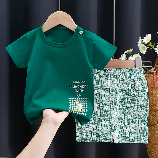 Green t-shirt and shorts set on a hanger against a dark background