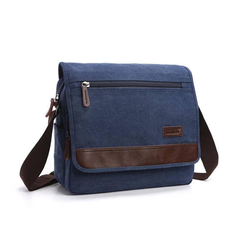 Blue canvas messenger bag with brown leather accents on a white background