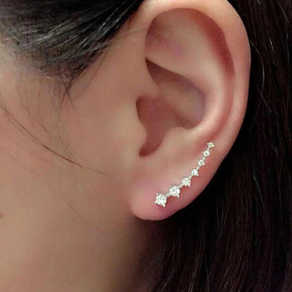 Close-up of an ear wearing a star-shaped earring.