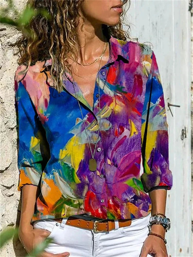 Person wearing a colorful abstract patterned shirt against a neutral background