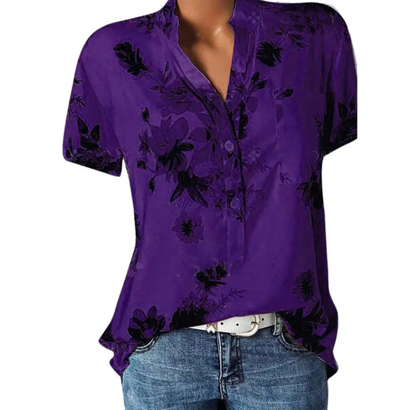 Purple floral blouse worn by a mannequin on a white background