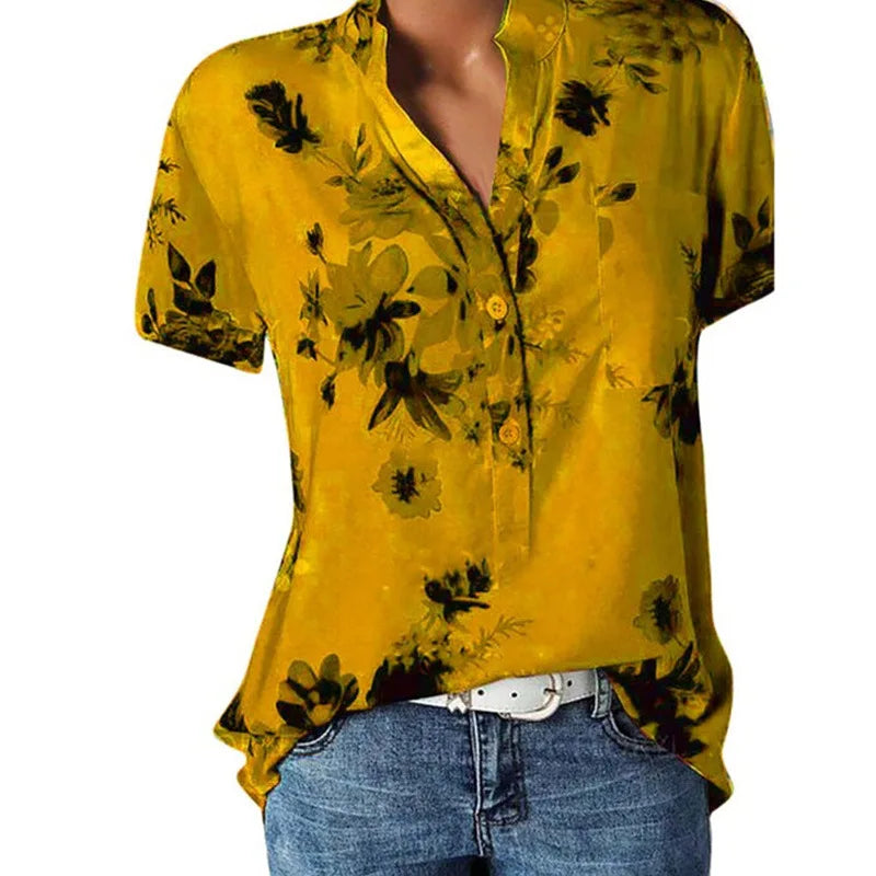 Yellow floral blouse worn by a person on a white background