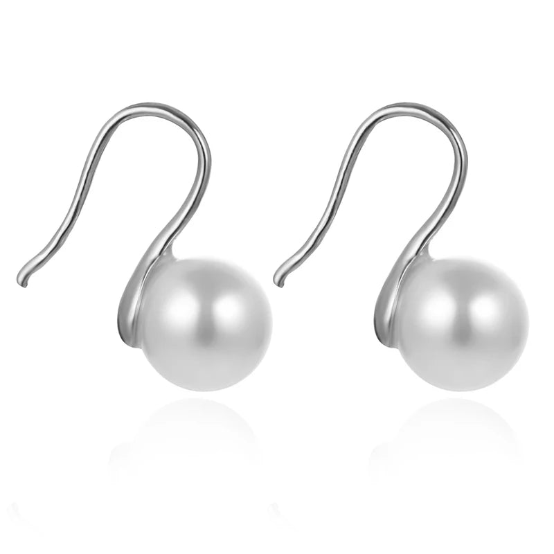 Pearl earrings with silver hooks on a white background
