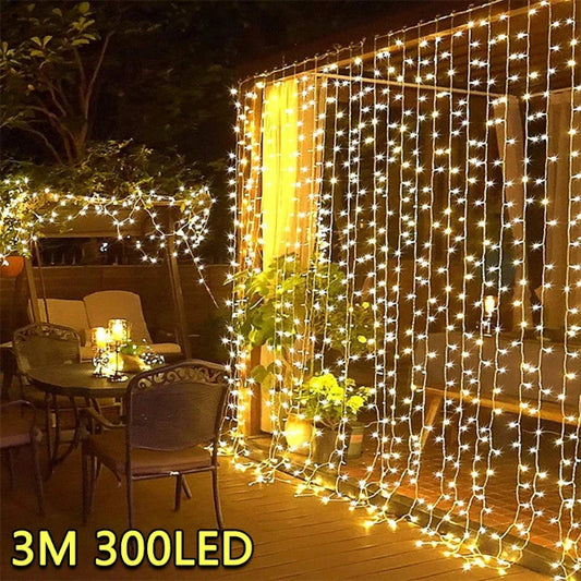 Curtain string lights hanging over a garden fence at night- 01