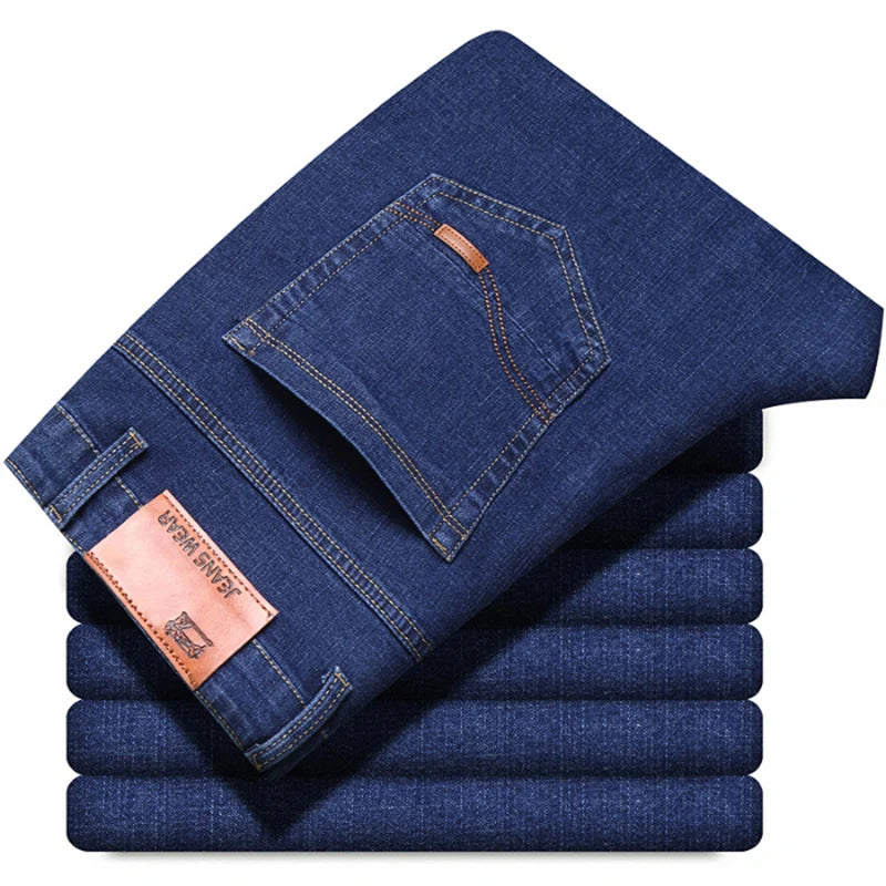 Stack of blue jeans with a brand label on a white background