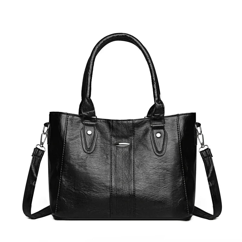 Black handbag with a shoulder strap on a white background