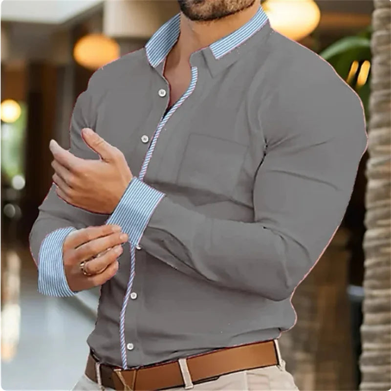 Man wearing a gray long-sleeve shirt with a blurred background