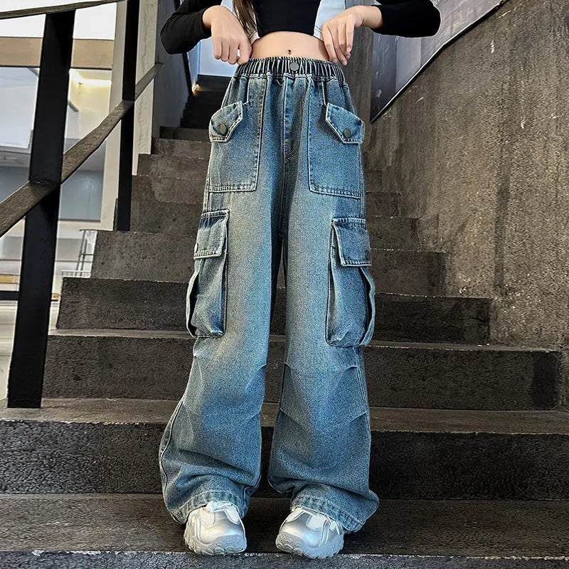Person wearing blue cargo jeans standing on a staircase.