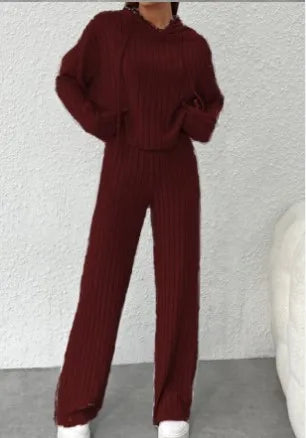 Maroon ribbed sweater and pants set on a neutral background