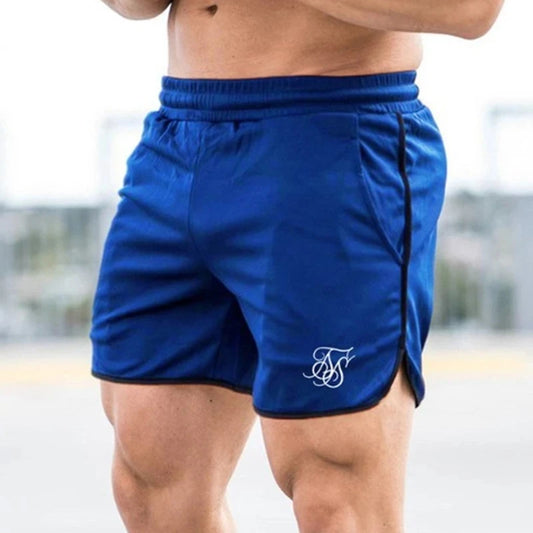 Blue athletic shorts with a logo on a blurred outdoor background