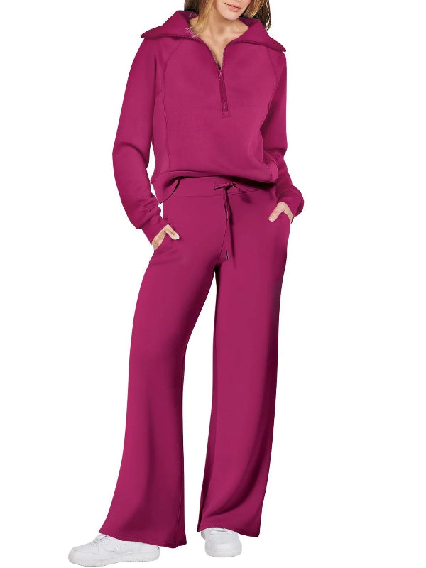 Person wearing a magenta tracksuit on a white background