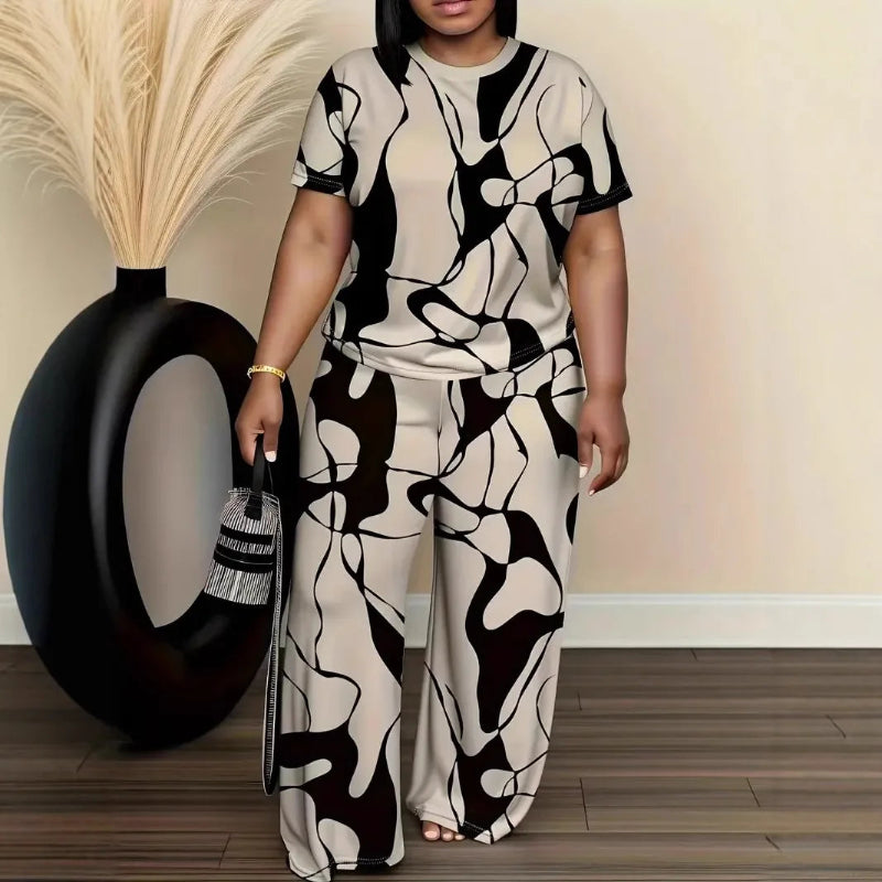 Woman wearing a black and white patterned outfit standing next to a decorative vase.