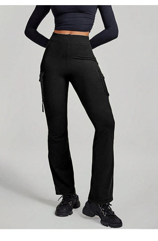 Person wearing black cargo pants on a plain background
