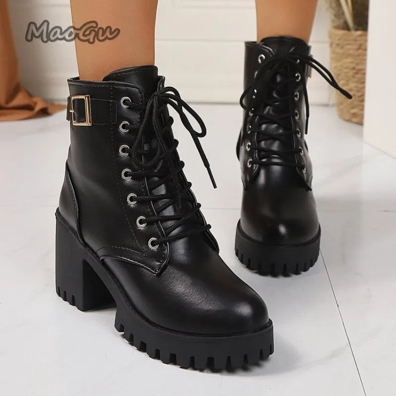 Black leather boots with chunky sole on a light background