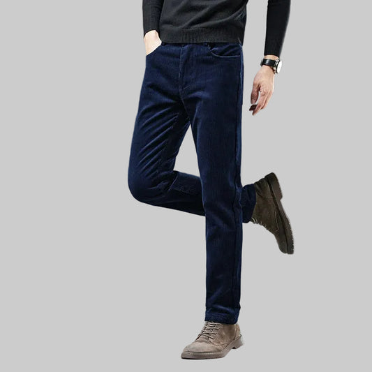 Person wearing dark blue pants and brown shoes on a gray background with 'HIQOR' branding.