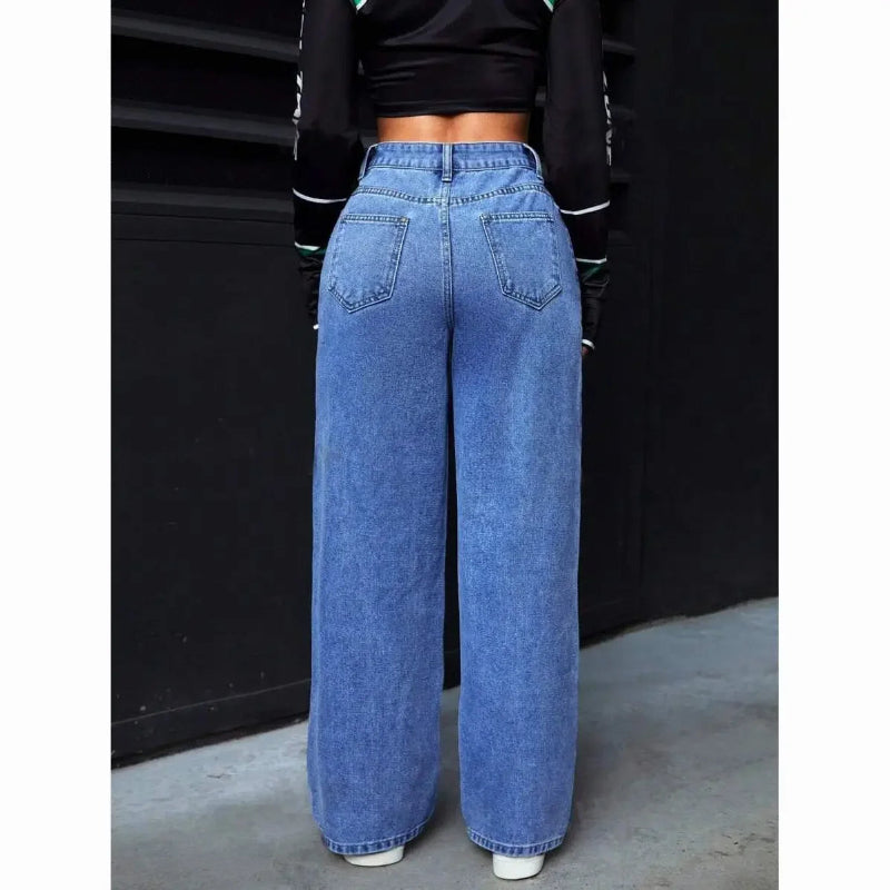 Person wearing blue wide-leg jeans against a black background