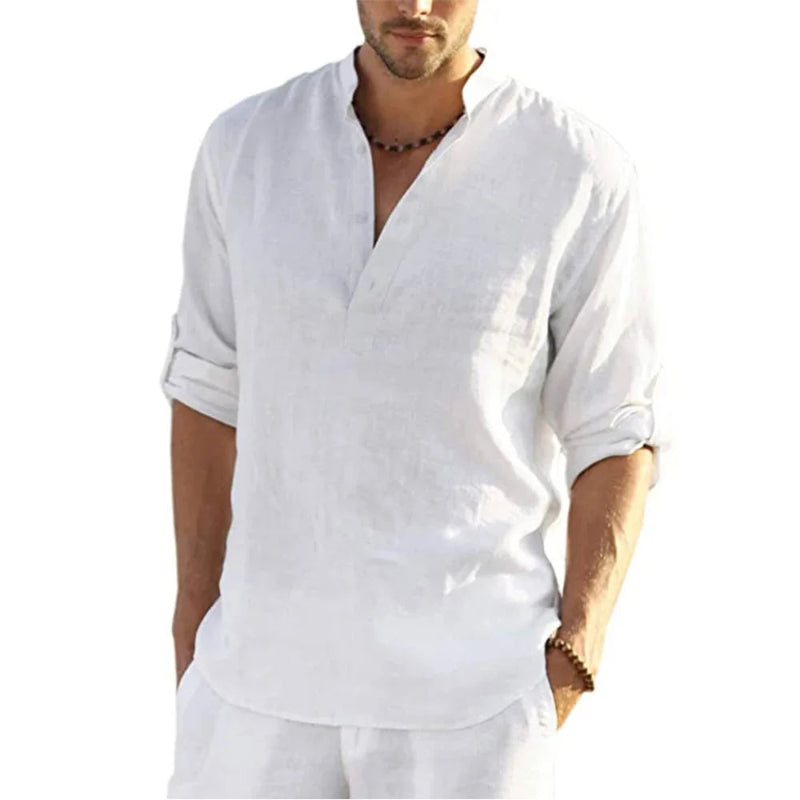 Man wearing a white shirt with a V-neck and rolled-up sleeves on a white background