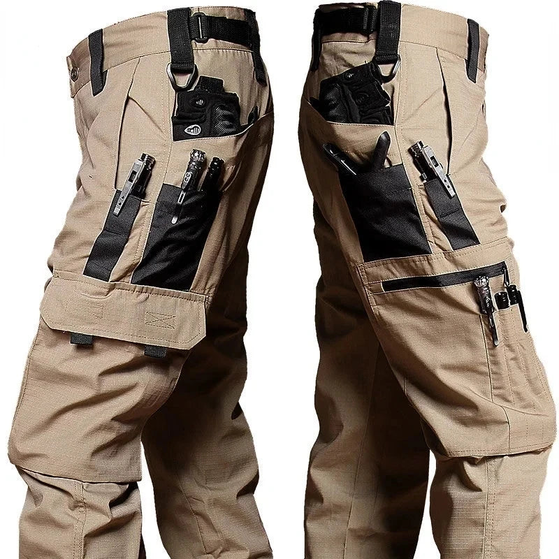 Tan tactical pants with multiple pockets and attachments on a white background