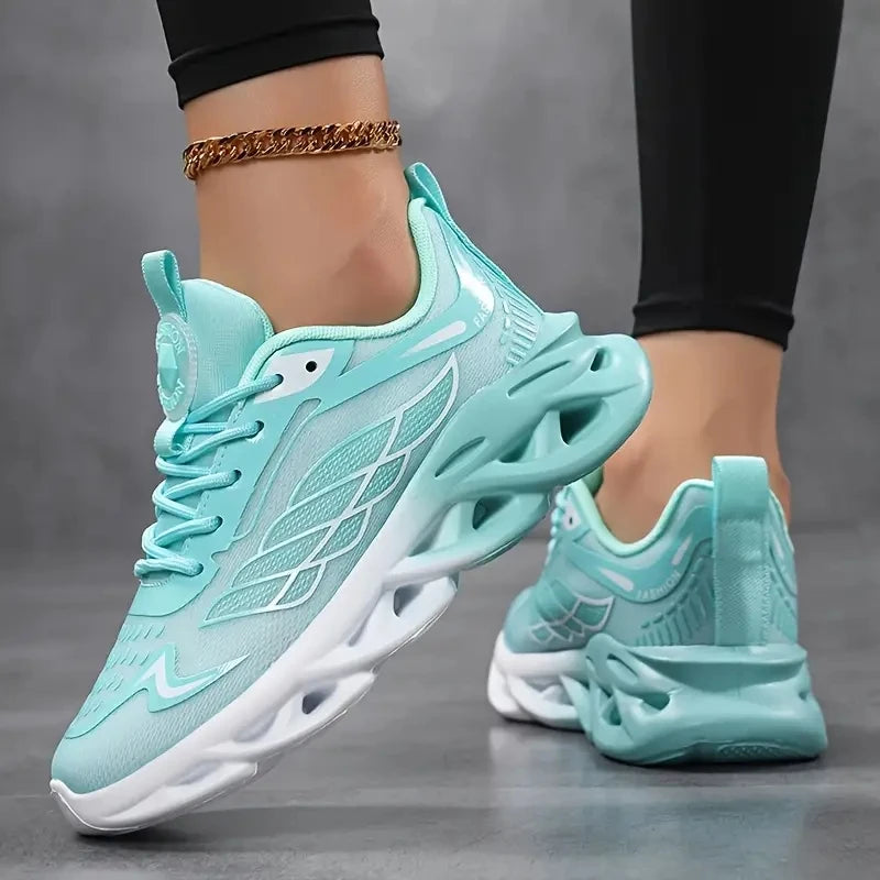 Turquoise running shoes with white soles on a gray background