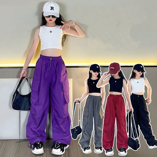 Woman in a white sleeveless top and purple pants with three smaller images of her in different colored pants.