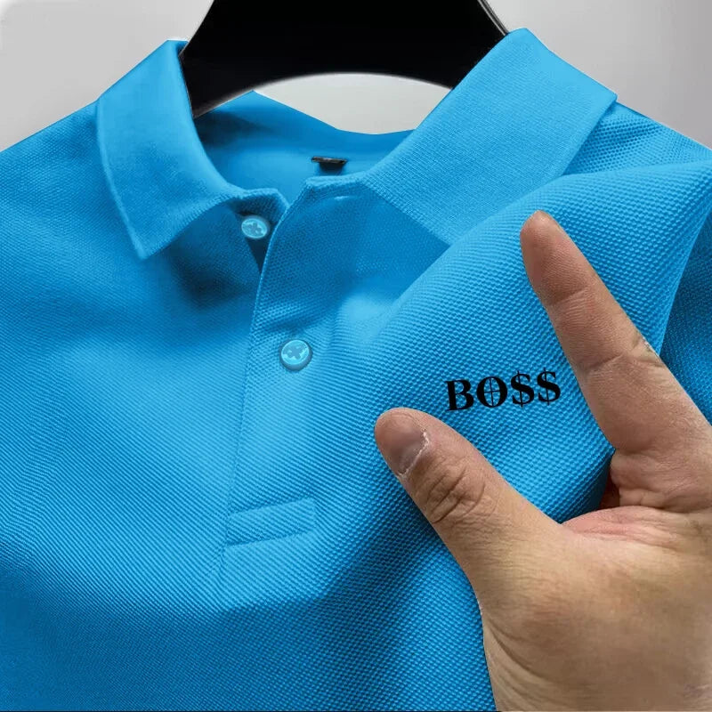 Blue polo shirt with 'BOSS' logo on a hanger, held by a hand.