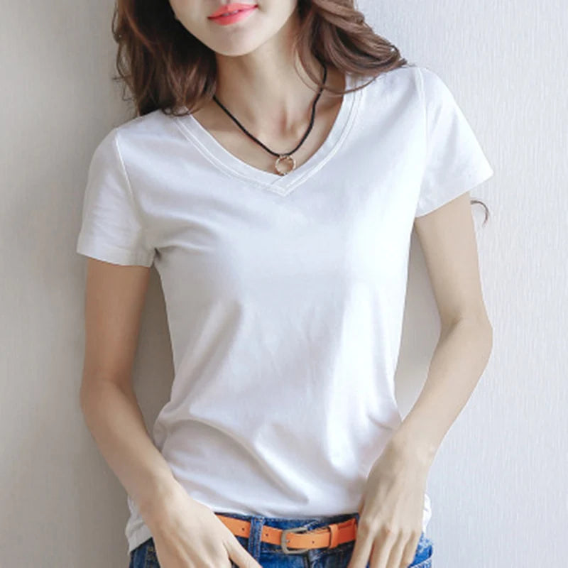 Person wearing a plain white t-shirt against a neutral background