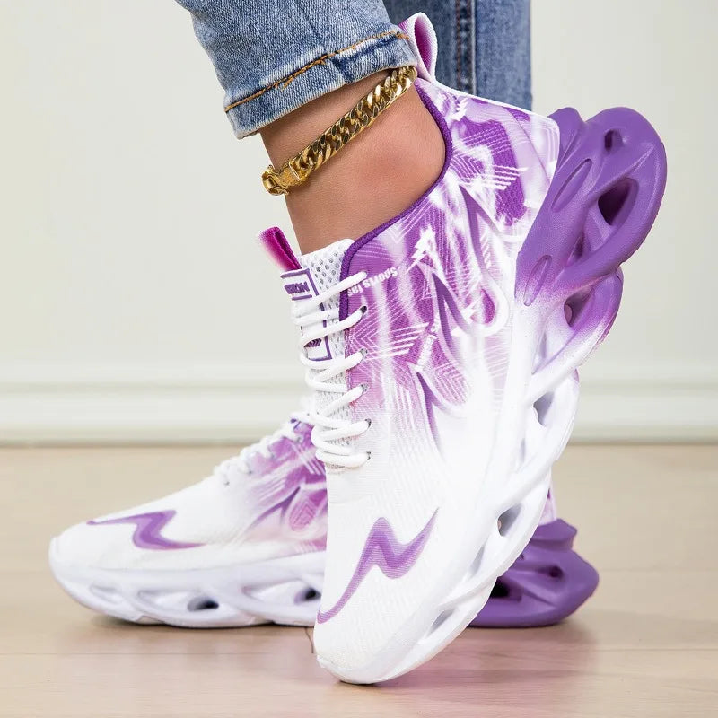 White and purple sneakers worn with denim jeans on a light background