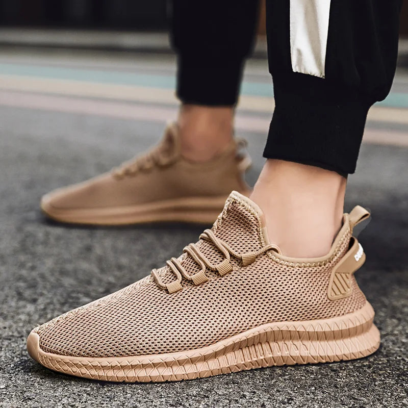 Beige sneakers worn on a blurred street background