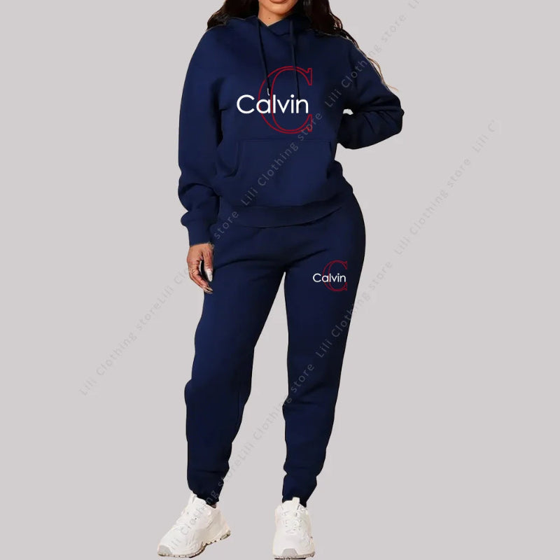 Person wearing a navy Calvin tracksuit on a gray background