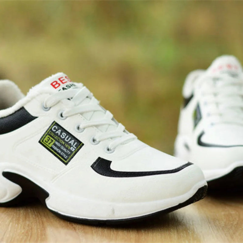 White sneakers with black accents on a wooden surface